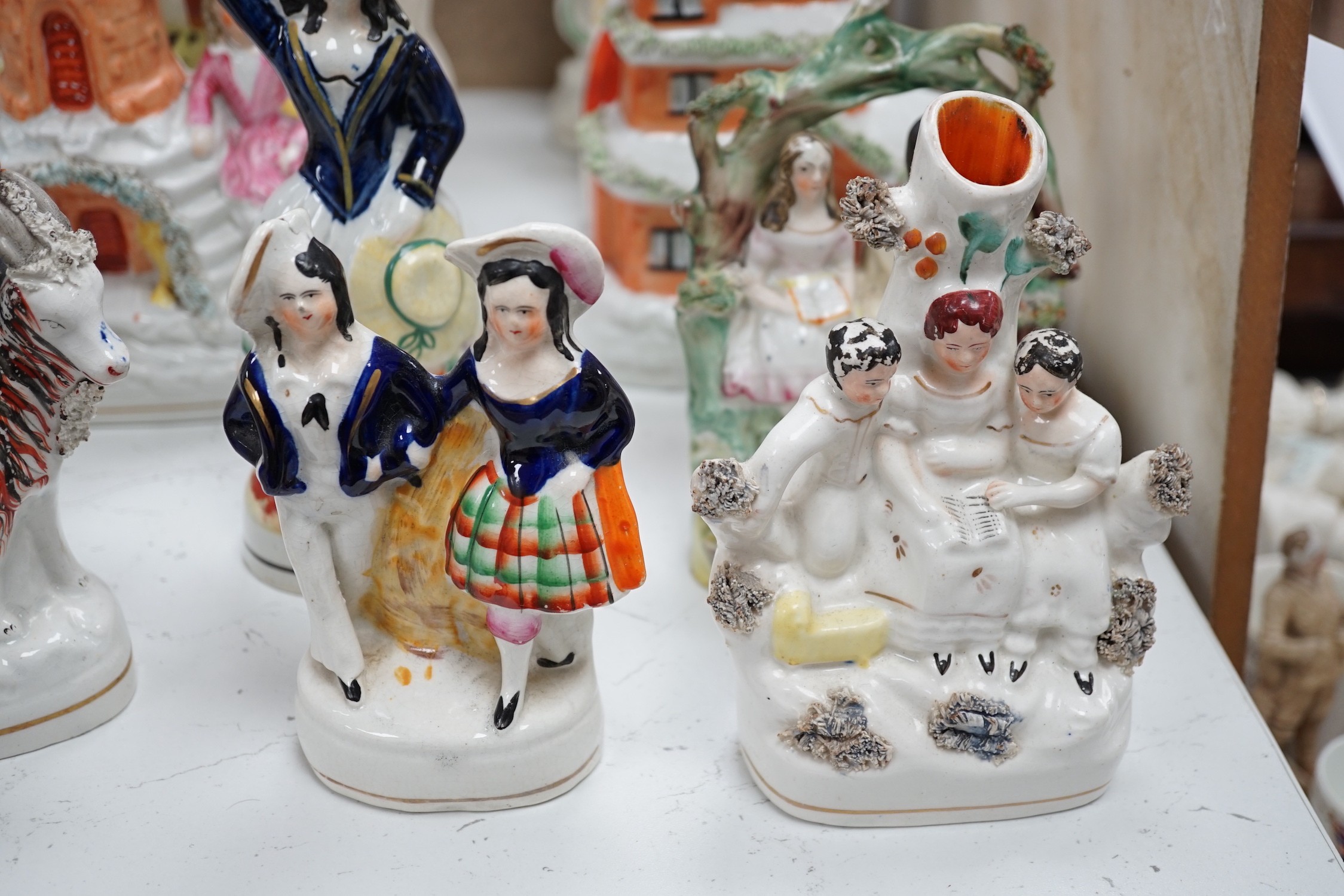 A collection of Victorian Staffordshire pottery flat-back figures and groups, tallest 29cm